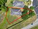 An aerial view shows the home with a spacious yard, mature trees, and proximity to the neighborhood at 1167 Stoney Creek Blvd, Lakeland, FL 33811