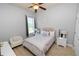 Well lit bedroom featuring a ceiling fan and a window with wood flooring at 1167 Stoney Creek Blvd, Lakeland, FL 33811