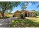 This single-story home boasts a well-maintained lawn, attached garage, and an arched entryway at 1167 Stoney Creek Blvd, Lakeland, FL 33811