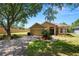 Charming single-story home with a well-manicured lawn, attached garage, and inviting front entrance at 1167 Stoney Creek Blvd, Lakeland, FL 33811