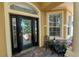 Charming front porch with decorative glass door and a small seating area at 1167 Stoney Creek Blvd, Lakeland, FL 33811