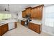 Open kitchen featuring custom wood cabinets, stainless steel appliances, and bright natural light at 1167 Stoney Creek Blvd, Lakeland, FL 33811