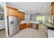 This kitchen features stainless steel appliances, tiled floors, and a breakfast bar that opens to the living room at 1167 Stoney Creek Blvd, Lakeland, FL 33811