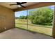 Screened-in lanai with views of the lush backyard and mature trees at 1167 Stoney Creek Blvd, Lakeland, FL 33811