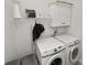 Functional laundry room featuring a front-load washer and dryer and shelving at 1167 Stoney Creek Blvd, Lakeland, FL 33811