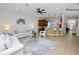 A bright living room featuring modern furnishings, a ceiling fan, and open access to the kitchen at 1167 Stoney Creek Blvd, Lakeland, FL 33811