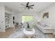 Bright living room with neutral furnishings, a modern ceiling fan, and sliding doors to the outside at 1167 Stoney Creek Blvd, Lakeland, FL 33811