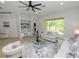 Bright living room featuring neutral decor, a ceiling fan, and a sliding glass door leading to the outside at 1167 Stoney Creek Blvd, Lakeland, FL 33811