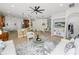Spacious living room with tile flooring, a modern ceiling fan, and an open floor plan connecting to the dining area at 1167 Stoney Creek Blvd, Lakeland, FL 33811
