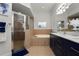 Bright and spacious main bathroom with double sinks, enclosed glass shower and soaking tub at 1167 Stoney Creek Blvd, Lakeland, FL 33811