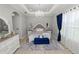 Luxurious main bedroom with tray ceilings, a chandelier, and a plush upholstered bed at 1167 Stoney Creek Blvd, Lakeland, FL 33811