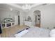Bright main bedroom with hard floors, a chandelier, and a decorative fireplace with TV at 1167 Stoney Creek Blvd, Lakeland, FL 33811