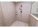 Tile shower featuring a handheld shower head, built-in shelving, and marble trim at 1167 Stoney Creek Blvd, Lakeland, FL 33811