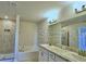 Bright bathroom featuring double vanity, soaking tub, and glass shower at 2303 Brassie Ct, Winter Haven, FL 33884