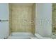 Bathroom features a tub with decorative tile surround and updated fixtures at 2303 Brassie Ct, Winter Haven, FL 33884