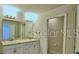 Bathroom with dual sinks, modern fixtures, and a glass-enclosed shower at 2303 Brassie Ct, Winter Haven, FL 33884