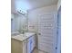 Bathroom featuring a granite countertop, modern fixtures, and a door leading to the toilet at 2303 Brassie Ct, Winter Haven, FL 33884