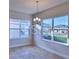 Cozy dining area bathed in natural light, complemented by modern chandelier at 2303 Brassie Ct, Winter Haven, FL 33884