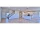 Open-concept living space flows into kitchen, featuring tile floors and plenty of natural light at 2303 Brassie Ct, Winter Haven, FL 33884