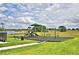 Community playground with swings and slide at 2303 Brassie Ct, Winter Haven, FL 33884
