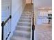 Carpeted staircase with decorative railing leads to the upper level of the home at 2303 Brassie Ct, Winter Haven, FL 33884