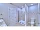 Modern bathroom with walk-in shower, dual sinks, and tiled floor at 2307 Brassie Ct, Winter Haven, FL 33884