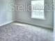 Bright bedroom features neutral carpeting, light walls, baseboard trim and a sunlit window at 2307 Brassie Ct, Winter Haven, FL 33884