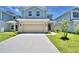 Charming home showcasing a well-manicured lawn and a two-car garage at 2307 Brassie Ct, Winter Haven, FL 33884