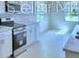 White kitchen features modern appliances, tile backsplash and ample counter space at 2307 Brassie Ct, Winter Haven, FL 33884