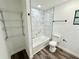 Bright bathroom featuring a tiled shower, modern fixtures, and luxury vinyl plank flooring at 2527 Dons Pl, Lakeland, FL 33801