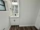 Bathroom featuring modern fixtures, a stylish vanity, and luxury vinyl plank flooring at 2527 Dons Pl, Lakeland, FL 33801