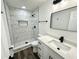 Modern bathroom featuring a tiled walk-in shower, updated vanity, and sleek fixtures at 2527 Dons Pl, Lakeland, FL 33801