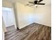 Spacious bedroom with laminate floors, a ceiling fan, and a closet with plenty of storage space at 2527 Dons Pl, Lakeland, FL 33801