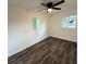 Clean bedroom showcasing luxury vinyl plank flooring, white walls, and natural light at 2527 Dons Pl, Lakeland, FL 33801