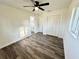 Bedroom with laminate flooring, a ceiling fan, closet space, and an ensuite bathroom at 2527 Dons Pl, Lakeland, FL 33801