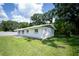 Charming single-story home featuring a well-maintained lawn and mature trees at 2527 Dons Pl, Lakeland, FL 33801
