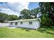 Lovely single-story home showcasing a well-manicured lawn and painted grey exterior at 2527 Dons Pl, Lakeland, FL 33801