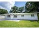 Cozy single-story home boasts a welcoming front yard and freshly painted grey exterior at 2527 Dons Pl, Lakeland, FL 33801