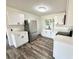 Bright kitchen featuring white cabinets, stainless steel appliances, and a large window at 2527 Dons Pl, Lakeland, FL 33801