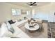 Modern living room with white furniture, marble coffee tables, neutral rug, and plenty of natural light at 2527 Dons Pl, Lakeland, FL 33801