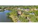 Aerial view of a waterfront home surrounded by trees and other luxury homes on the lake at 3906 Canyon Lake Pt, Lakeland, FL 33813