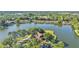 Stunning aerial view of lakefront home with lush landscaping and mature trees at 3906 Canyon Lake Pt, Lakeland, FL 33813