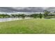 Expansive backyard featuring lake views and green lawn at 3906 Canyon Lake Pt, Lakeland, FL 33813