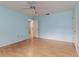 Empty bedroom features blue walls, hardwood floors, bright natural light, and an ensuite bathroom at 3906 Canyon Lake Pt, Lakeland, FL 33813
