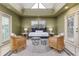 Sunroom setup as a bedroom with natural light, decorative chairs, and an area rug at 3906 Canyon Lake Pt, Lakeland, FL 33813