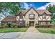 Charming home with stone and brick exterior, a manicured lawn, and mature trees at 3906 Canyon Lake Pt, Lakeland, FL 33813