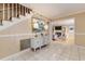 Elegant foyer with staircase, tile flooring, and an inviting view of the living room at 3906 Canyon Lake Pt, Lakeland, FL 33813