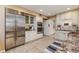 Well-lit kitchen with stainless steel fridge, granite counters, and off-white cabinetry at 3906 Canyon Lake Pt, Lakeland, FL 33813