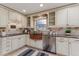 Bright kitchen features a stainless dishwasher, a copper sink and granite countertops at 3906 Canyon Lake Pt, Lakeland, FL 33813