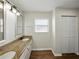 Spacious bathroom with long granite countertop, double sinks, and a large closet at 4965 Goldenview Ln, Lakeland, FL 33811